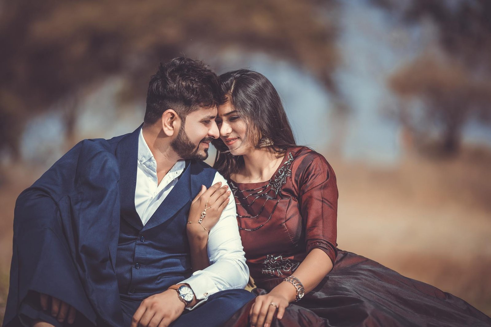 selective focus photography of man and woman sitting on ground